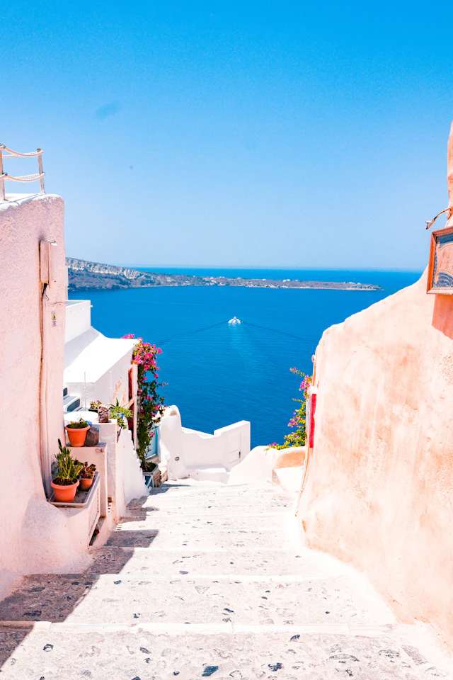Whitewashed steps leading towards the blue sea on Santorini