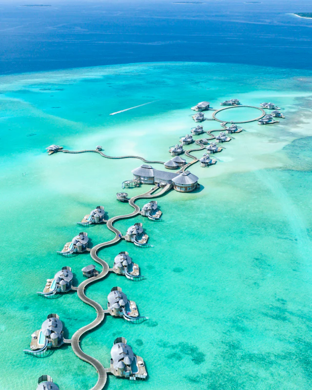 A ribbon of island villas over a clear turquoise lagoon